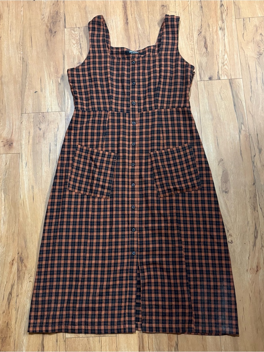 Brown and black plaid button front midi dress
With pockets